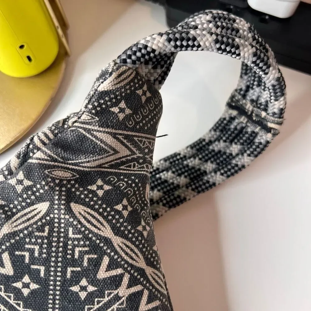 This item is a KAVU Rope Bag with a geometric black and white design